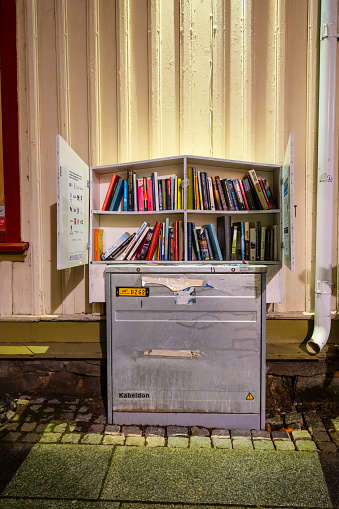 Gothenburg, Sweden - October 21 2023: Free library on top of a cable box.
