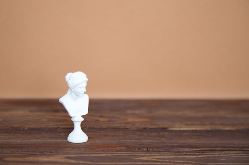 White marble sculpture bust on wooden background, mockup