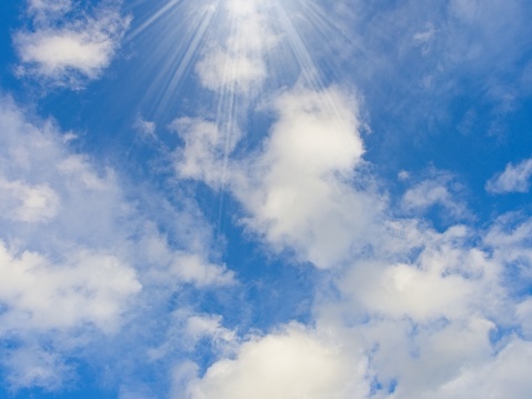 Cumulus clouds with sunbeam, a cloudscape design background.
