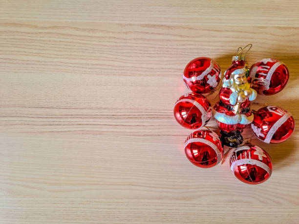 Christmas arrangement, hanging red decorations isolated on wooden background. Place for inscription. High quality photo