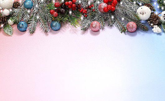 Beautiful Christmas and New Year background with lights, decorations, toys with fir branches with place for text. Holiday card, banner on screen, product setup for holiday advertising, Christmas Eve concept, selective focus,
