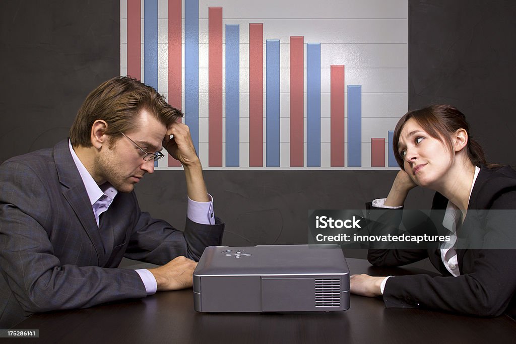 Meeting About Business Failure in a Conference Room meeting in a conference room with projector and chart Adult Stock Photo