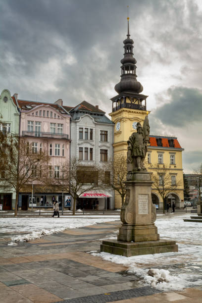 View of Masaryk Square, central square of Ostrava city overlooking Old Town Hall and Marian column on a snowy cold winter morning.\nOstrava, Czech Republic - February 1st 2019: