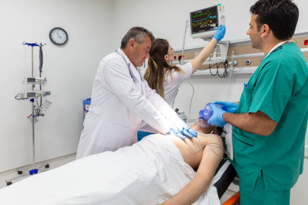 istock Doctors in emergency room working on unconscious patient. Doctors and nurses giving first aid to a patient who had a heart attack in the emergency room. 1752876154
