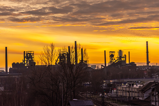 Cityscape of European city of Ostrava at Sunset. \nVitkovice Steel factory and manufacturing plant, home to colours of Ostrava and Beats for love -  seen in the background of this bright orange sunset\nTaken:\nOstrava, Czech Republic 30th December 2019