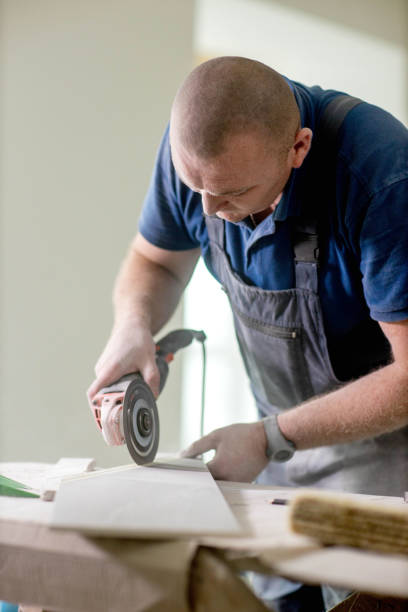 istock Professional tiler cutting tile with angle grinder. Construction, renovation, repair apartment. 1752880975