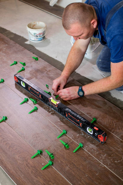 istock Tiler put clips in lash tile leveling system on the floor in a new house 1752895627
