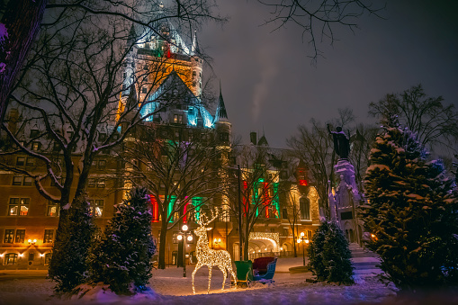 Place d'Armes and historic Fairmont Le Chateau Frontenac hotel during winter holidays, with Christmas decorations including reindeer and sleigh, old Quebec City, Canada. Photo taken in December 2022.