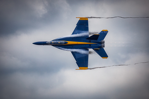 Miramar, California, USA - September 21, 2023: Vapor breaks around a US Navy Blue Angel on a cloudy day at America's Airshow 2023.