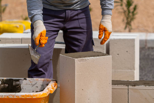 istock The bricklayer is working. Building a wall of aerated concrete. 1752923199