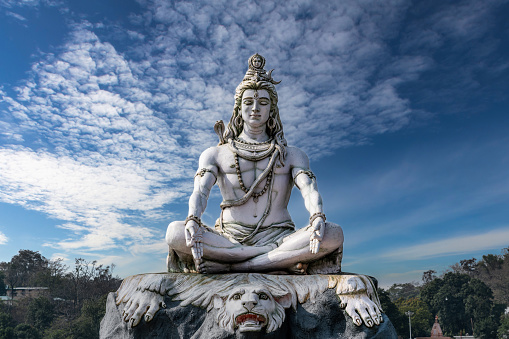 Lord Shiva statue on the banks of the sacred Ganges River in Rishikesh, India.