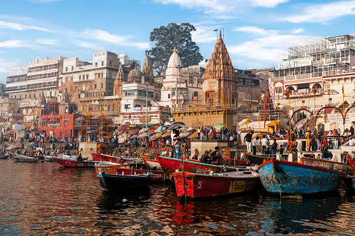 Colourful scene showing boats on the sacred Ganges River at Dashashwamedh Ghat in the holy city of Varanasi, Uttar Pradesh, India.