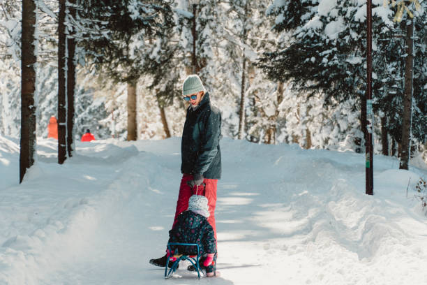 istock Mother with daughter in snow covered mountain 1752946224