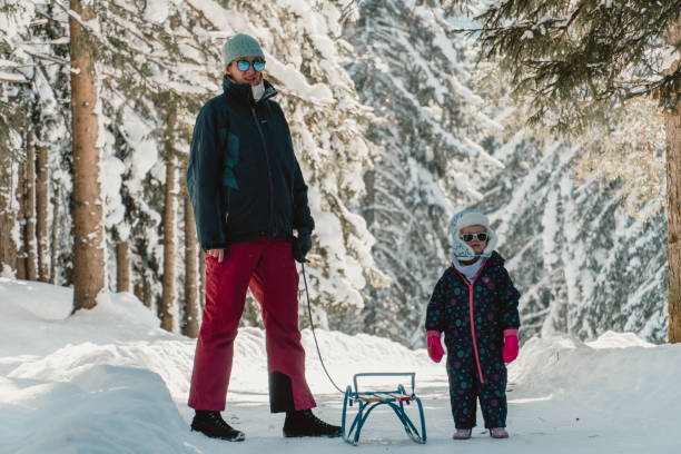 istock Mother with daughter in snow covered mountain 1752948363
