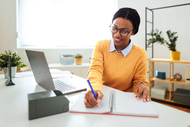 istock Well dressed businesswoman taking notes while working at the office 1752948903