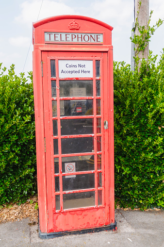 Red British phone box with a sign saying \