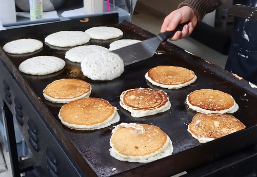 Flipping Pancakes at a breakfast fund raiser