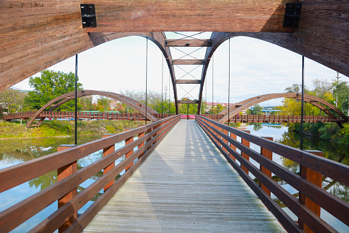 Midland's three-way 'Tridge' on a bright summer day is the symmetrical intersection of three elevated walkways on a recreation trail. Abstract architecture.