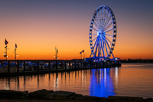 Photo of the Capital Wheel at sunset. This large Ferris wheel is located just outside of Washington DC, in the National Harbor in Maryland.