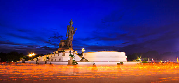 istock Buddha statue candle lit in lent day thailand 175316698