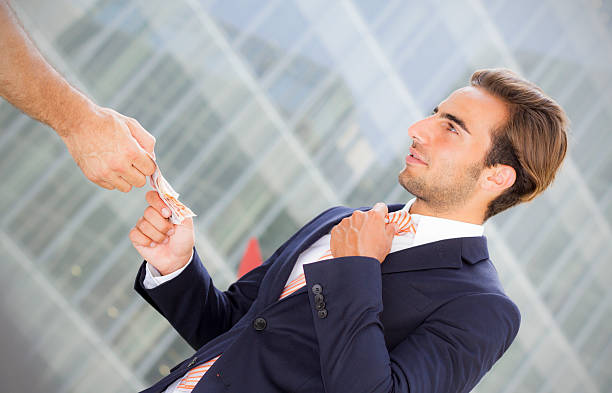 istock Young businessman outside office taking banknotes 175316824