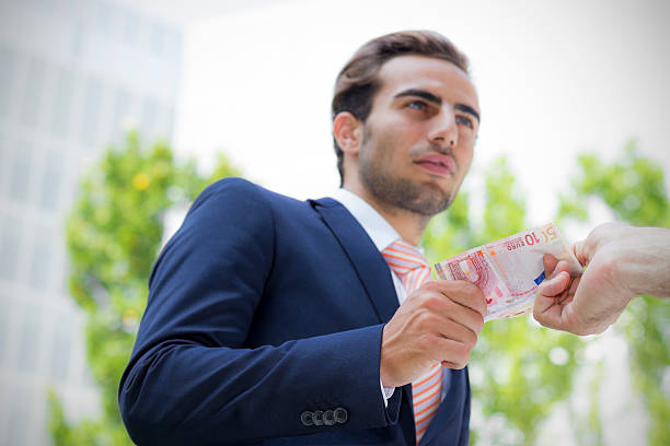 istock Young businessman outside office taking banknotes 175316839