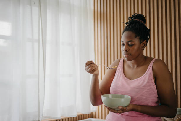 istock A black woman enjoying cereal in the kitchen 1753174462