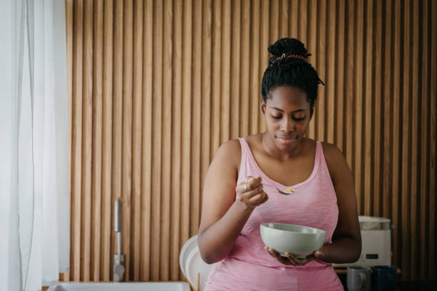 istock A black woman enjoying cereal in the kitchen 1753174464