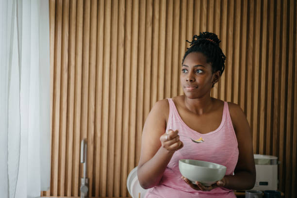 istock A black woman enjoying cereal in the kitchen 1753174468