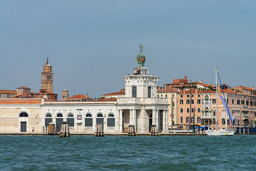 View of Ponta della Dogana from the Giudecca Canal at Venice, Italy. The building Dogana da Mar in Dorsoduro was built in the 15th century for customs and docking porposes and is now an art museum. It is right in the point where Grand Canal and Giudecca Canal meet and in front of the main island of Venice and it can be seen from the main island through the Grand Canal.