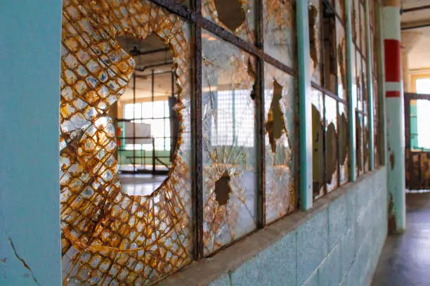 Old window with broken glass inside Alcatraz main cell house.
