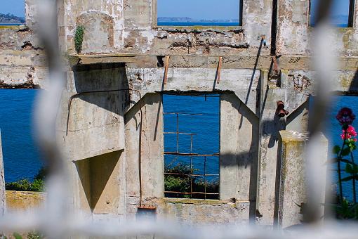 A view through the fences. From the second to the first floor of the Officer's Club ruins in Alcatraz Federal Prison.