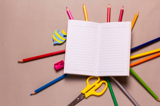 istock Blank notebook and school stationery on grey background. 1753210925