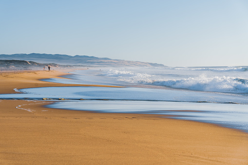 Sea waves, and clear blue sky on a sunlit day, blending tranquility and awe-inspiring nature, California