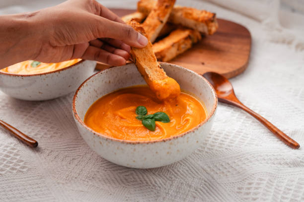 istock Pumpkin soup with toast on a wooden cutting board 1753250318