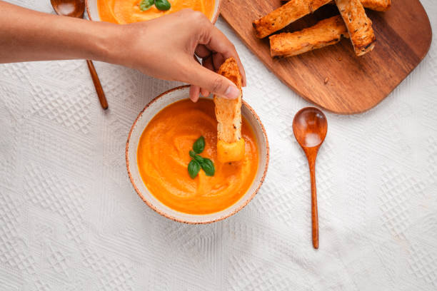 istock Pumpkin soup with toast on a wooden cutting board 1753250320