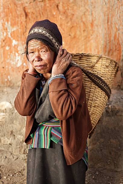 istock Tibetan woman carrying basket 175325456