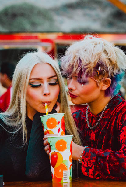 istock Young lesbian couple drinking soda together while having a date. 1753274748