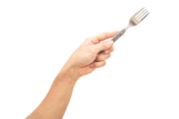 istock isolated of a man's hand holding a silver steel fork. 1753315451