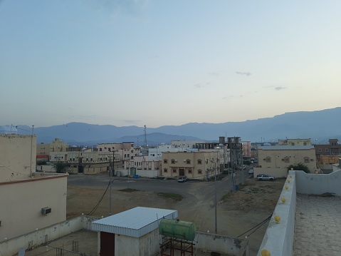 Saudi Arabia, Al Bahah, October 10-24-2023,early morning photo of the small, quiet city of Al-Hajra, with its buildings and palm trees, located in the middle of the Hijaz Mountains