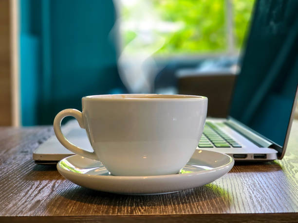 istock Laptop and coffee cup on wooden table 1753422802