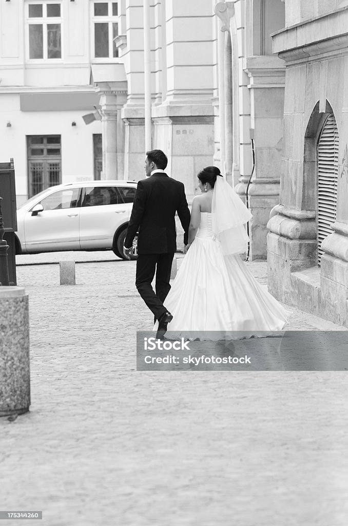 Os recém-casados sair da town square - Foto de stock de Adulto royalty-free