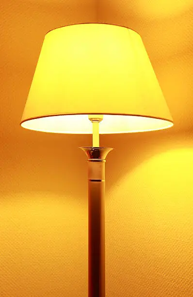 Floor lamp with shadow in hotel room