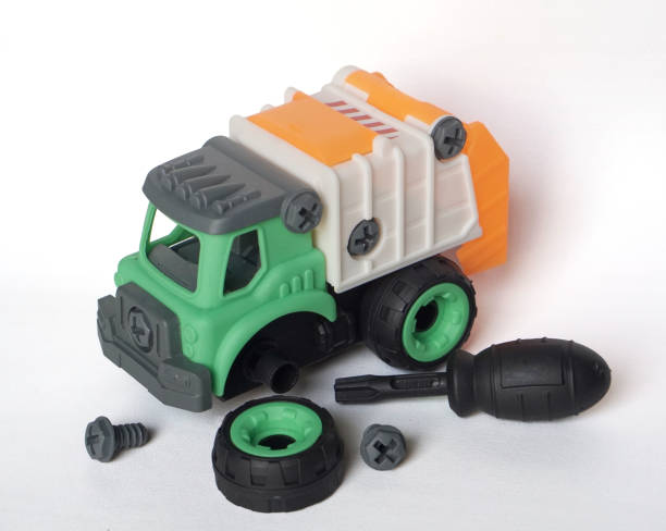 istock DIY plastic garbage truck toy isolated on white background with bolt and screwdriver. 1753471700