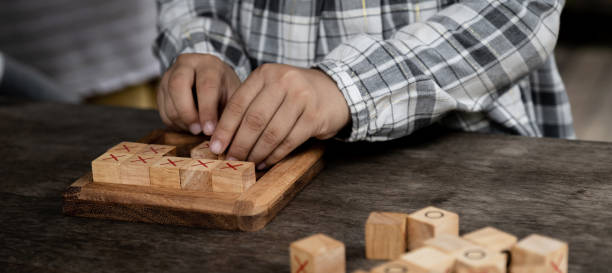 istock hands kid playing the wooden block game is a way to learn, and develop a way of thinking about concepts, potential and the brain 1753478852