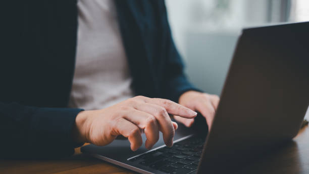 istock Man hand typing on computer laptop keyboard and pointing finger to screen 1753501907