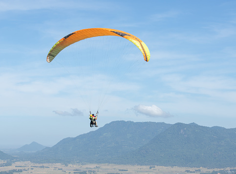 Paragliders are practicing flying in the blue sky, An Giang province, Mekong Delta