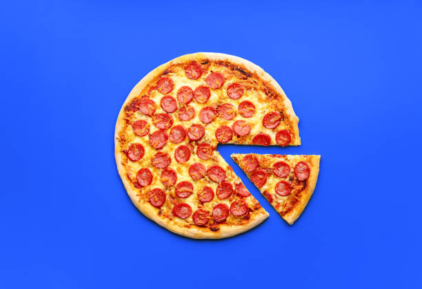 istock Homemade pepperoni pizza isolated on a blue background 1753508497