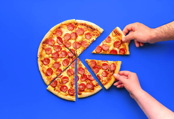 istock Homemade pizza with pepperoni, minimalist on a blue table 1753508509