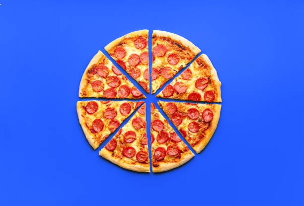 istock Sliced pepperoni pizza minimalist on a blue table 1753508534